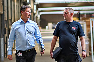 VELUX Commercial employee walking with customer in a commercial building