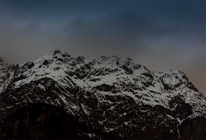Mountain top covered in snow at dawn