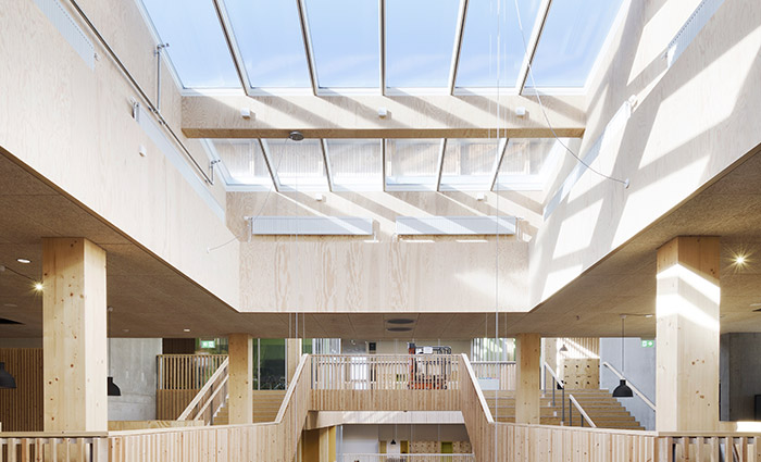 Bright school interior featuring a glass roof atrium that fills the space with natural daylight