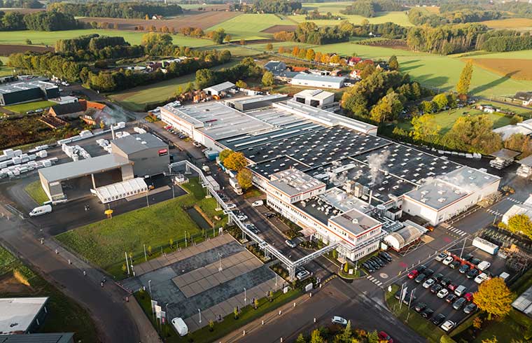 Aerial view of a large factory complex surrounded by green fields and rural landscape factory in Hüllhorst